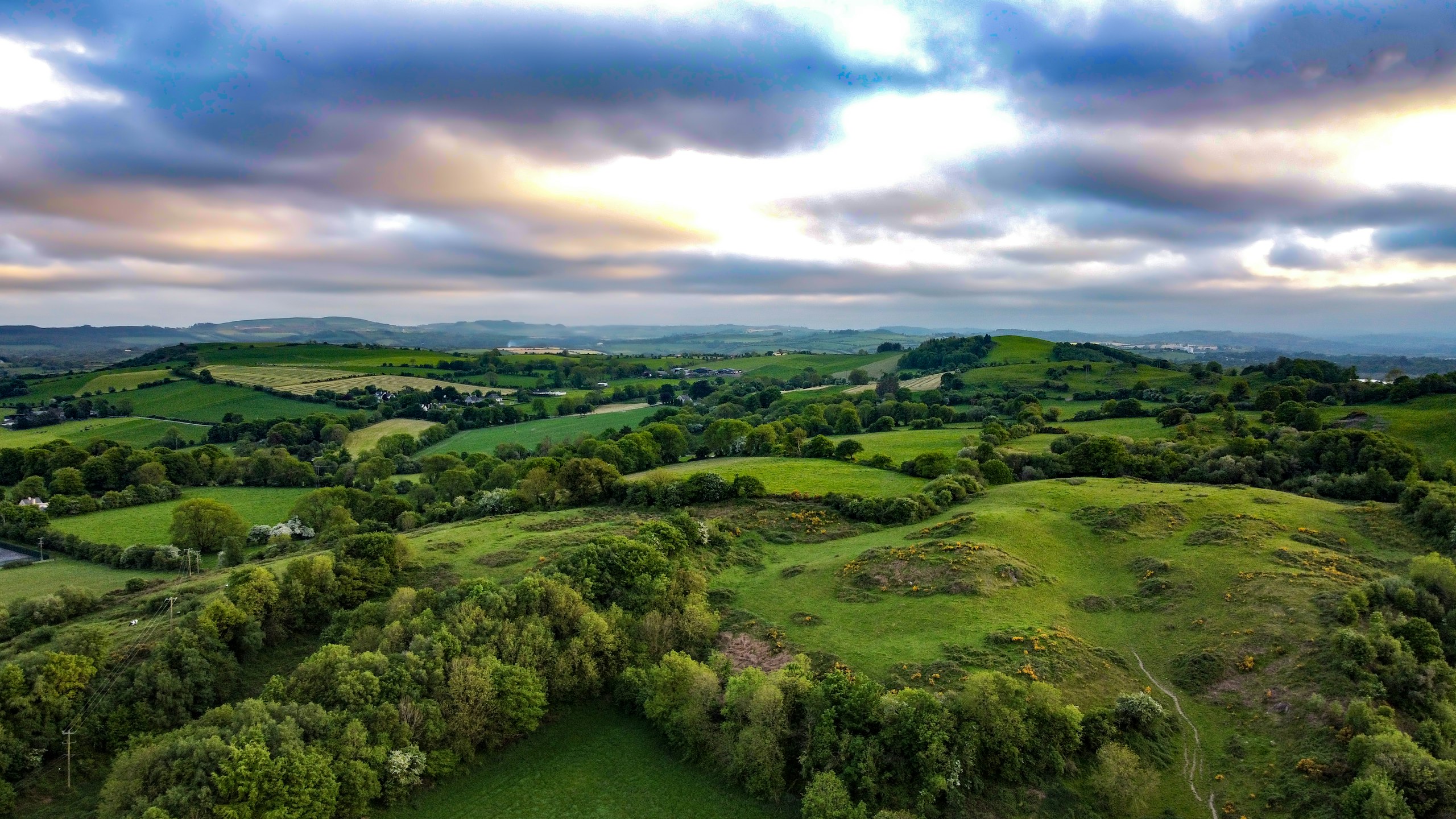 Green fields under a cloudy Irish sky